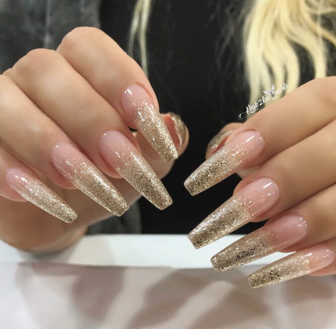 nails featuring a nude base with gold glitter gradient tips