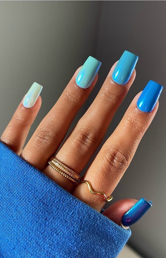 nails with a glossy ombré gradient from light to deep blue