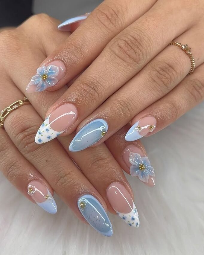 Light blue almond nails with 3D flowers, swirls, and dotted tips
