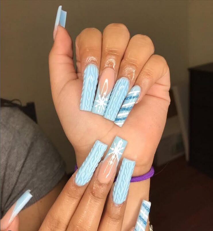 light blue sweater nails with snowflake and stripe accents