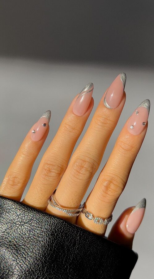 Pink almond nails with silver chrome tips and small rhinestone accents