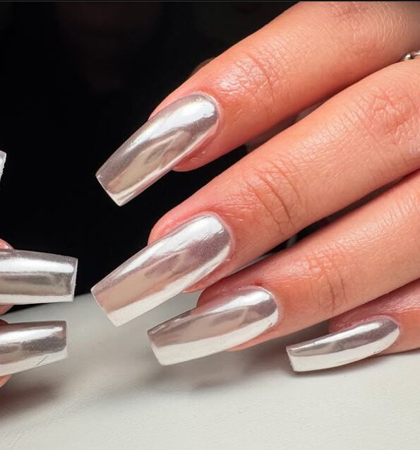 Hand with pointed-shaped metallic chrome nails