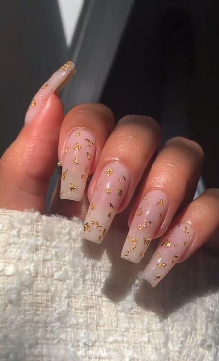 long nude coffin nails with delicate gold foil flakes