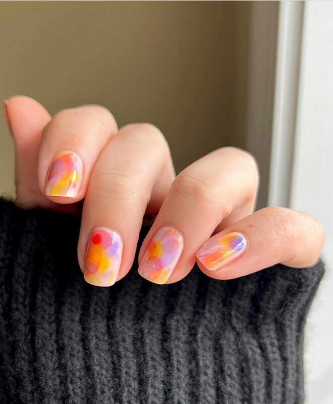 Mixed nails with orange in different finishes