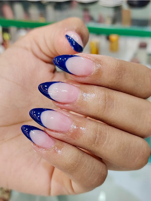 Sheer nails with crisp navy blue French tips
