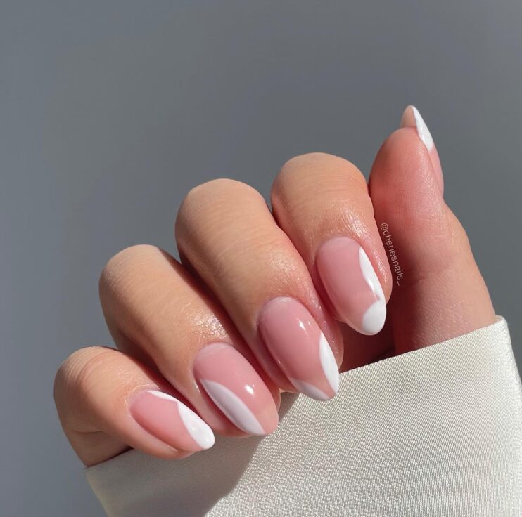 Nails with clear gaps or unpainted sections within the French tip area
