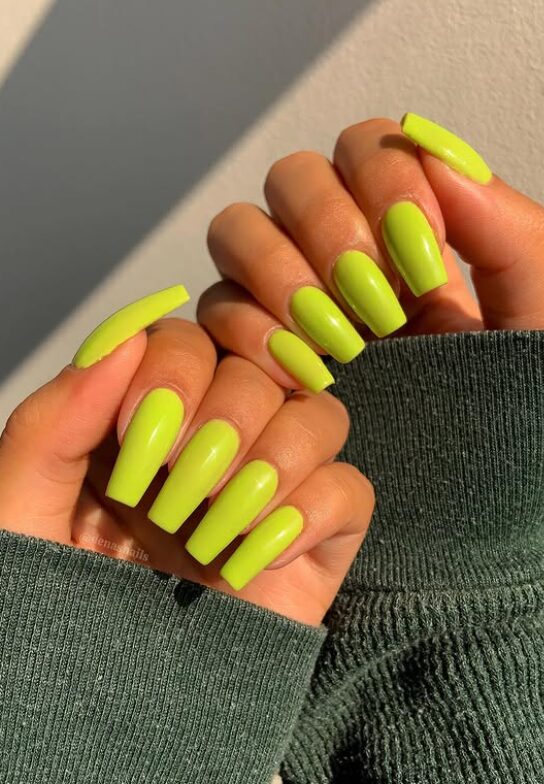 Bright neon green coffin nails with a glossy finish