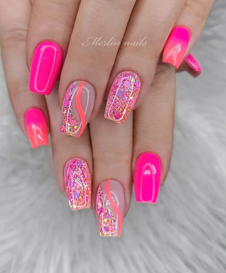 neon pink nails with glitter accents