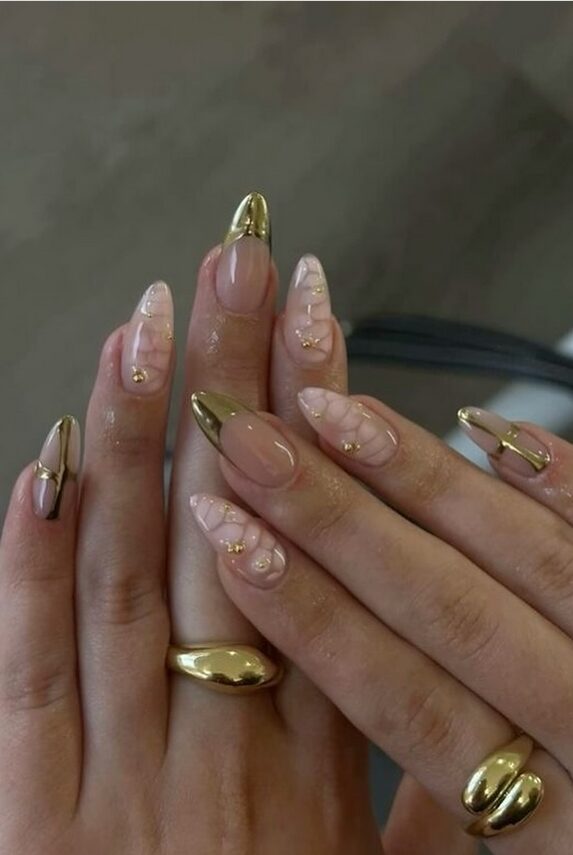 Nude almond nails with gold chrome tips