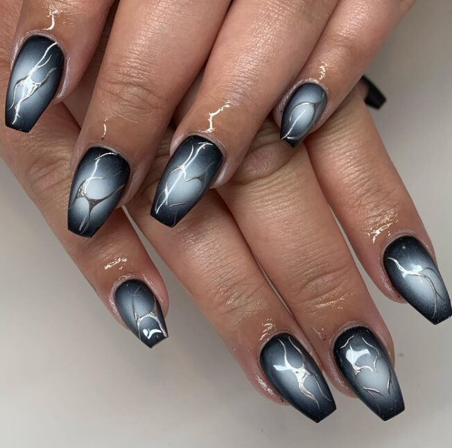 Black and silver ombre coffin nails with a marble effect and metallic vein detailing