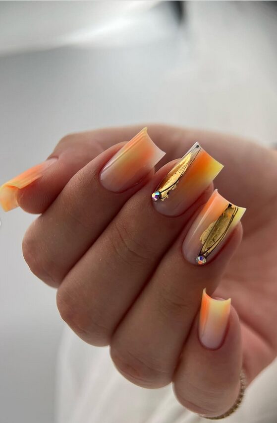 clear nails with one accent nail or tip painted bright orange