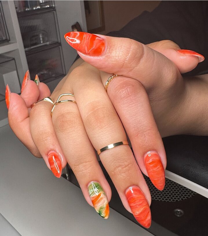 Orange marble pattern on coffin-shaped nails