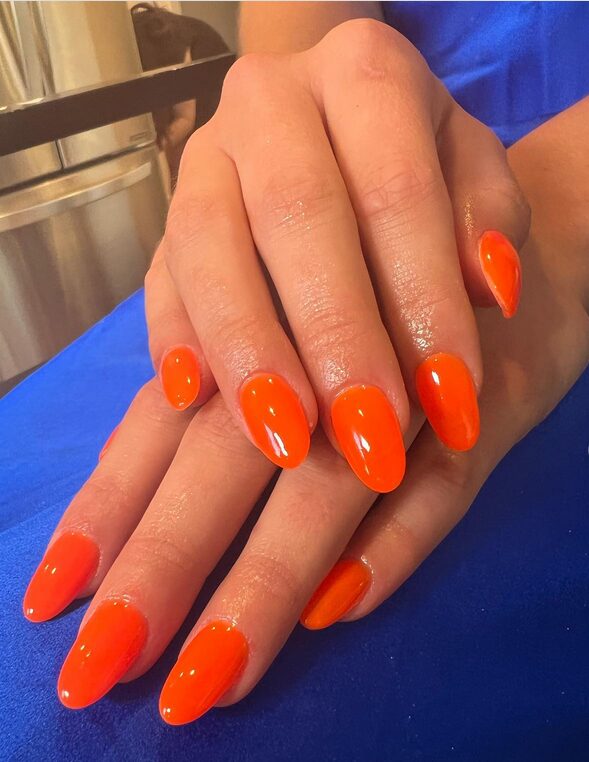 Neon orange nails in glossy finish