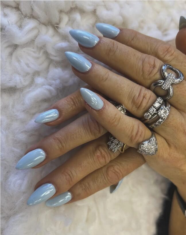 Shiny pale blue chrome nails on almond shape