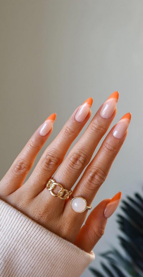 Almond nails in muted peach-orange shade