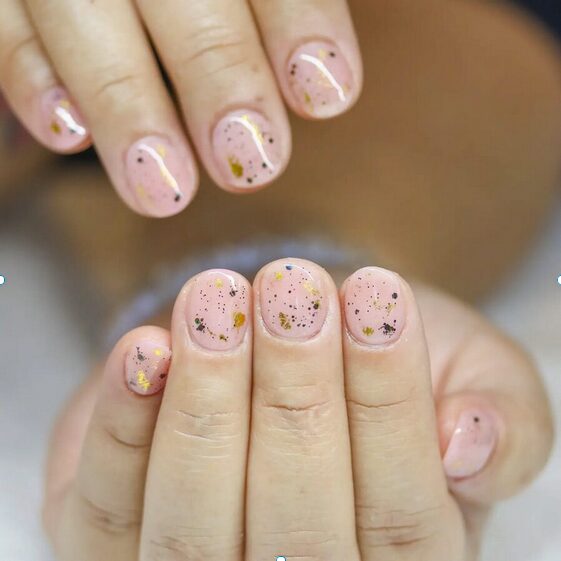 pink speckled spring nude nails on short natural manicure