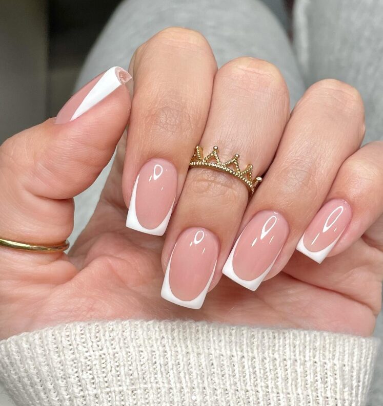Close-up of manicured hands showing side French accent nails