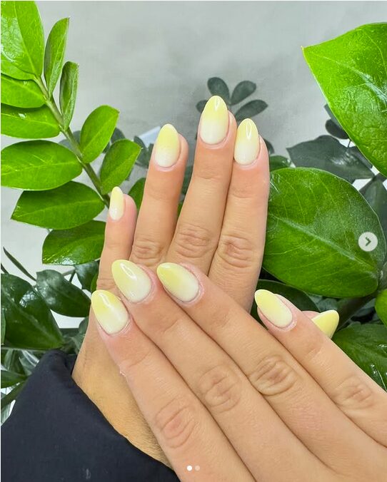 Soft yellow ombre nails with a glossy finish