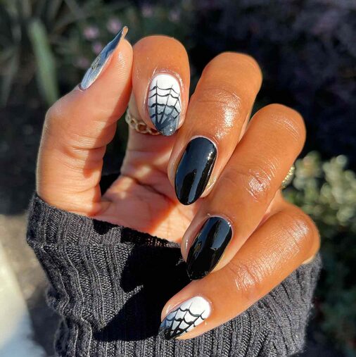 Black and white nails with 3D spider design