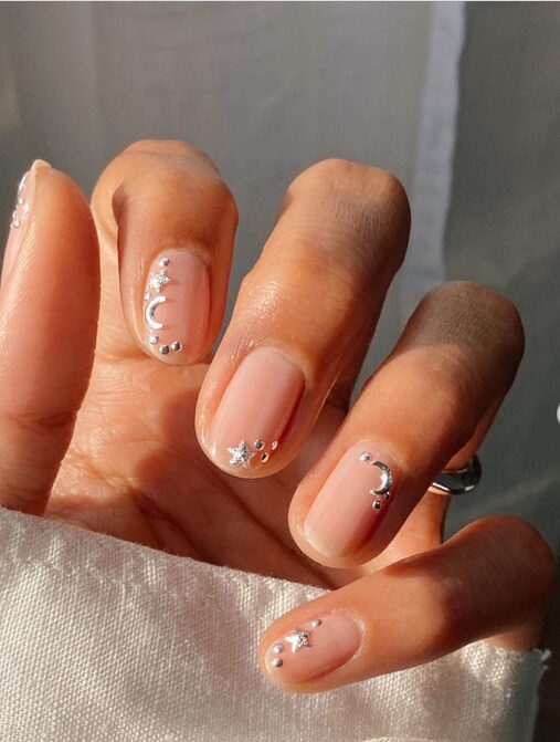 french Christmas manicure with stars and moon accents
