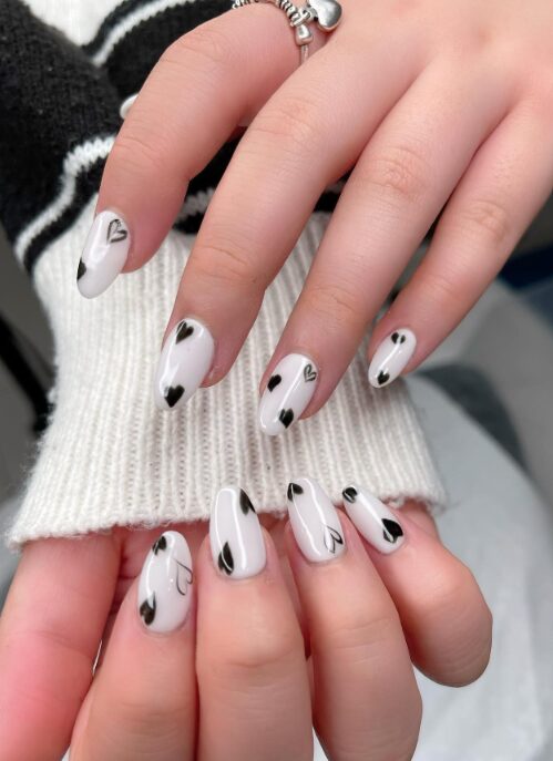 black and white nails with contrasting hearts