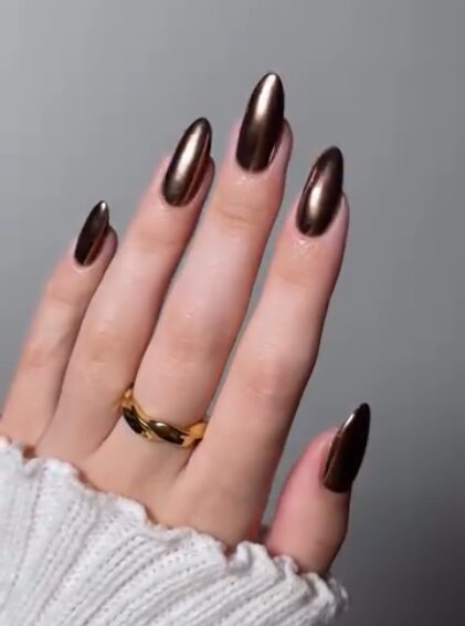 Bronze chrome manicure with mirror finish and metallic warm glow