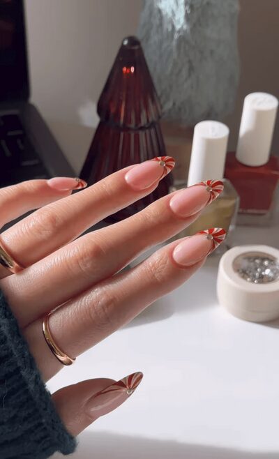 Classic white tips nails with red candy-cane stripes
