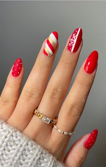 red nails with glitter, stars, and peppermint accents