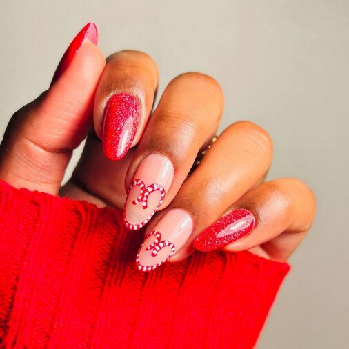 Red and white nails with heart-shaped swirl designs