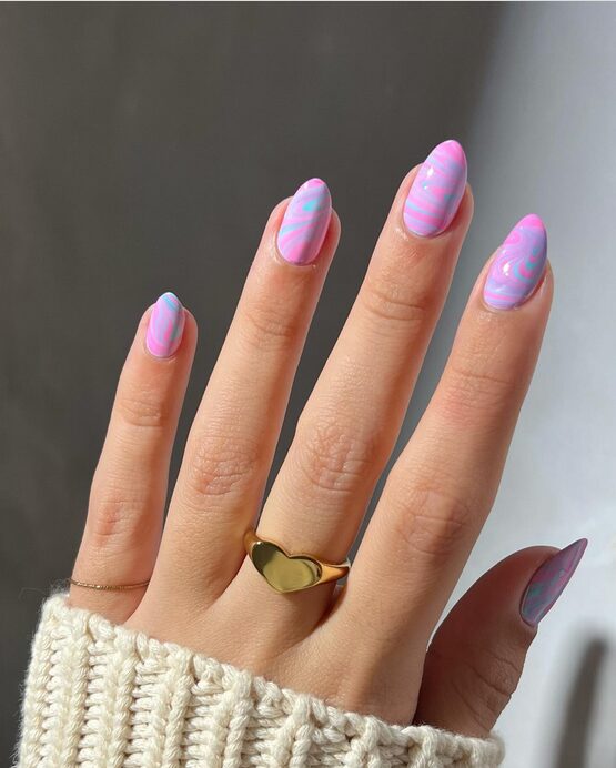 Close-up of candy-inspired water-marble nails featuring swirls of pink, mint, and lavender with a glossy finish