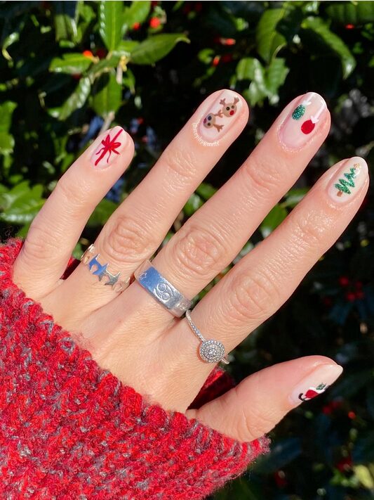 Close-up of hands displaying Christmas mix and match nail art