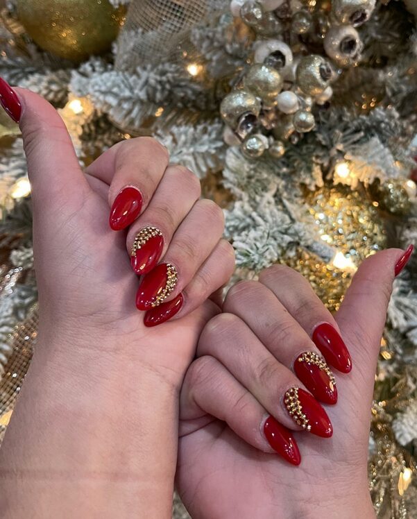 Deep red nails with gold foil accents