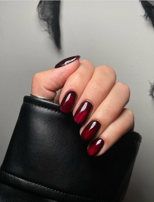 Deep crimson red nails in gothic vampire-inspired nail design