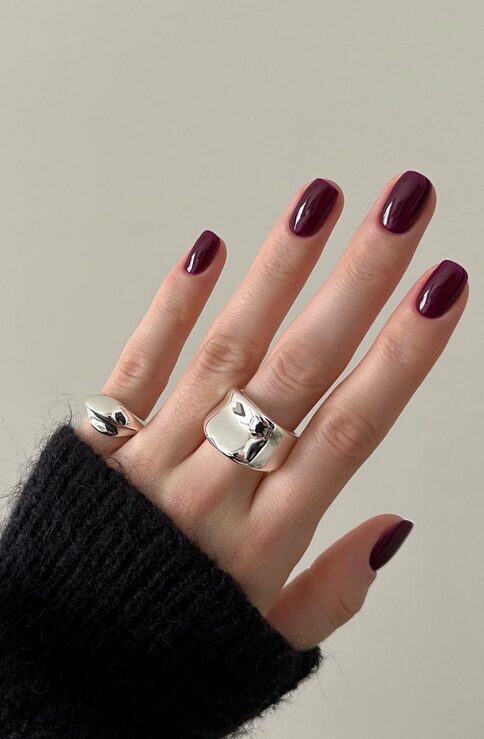 Glossy burgundy nails closeup