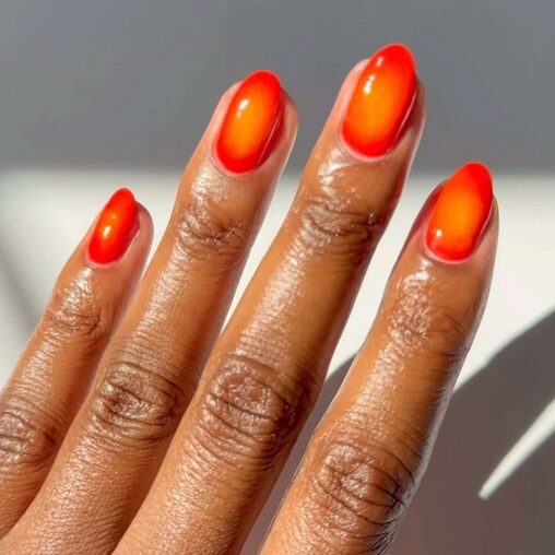 aura nails with a glowing gradient of orange and fiery ember shade