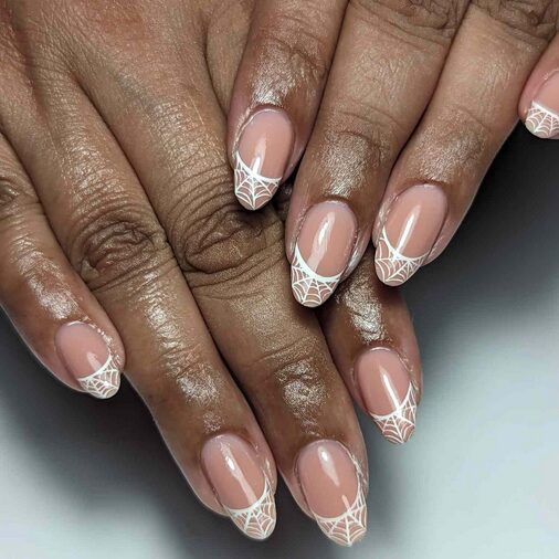 Negative space nails with white spiderweb designs