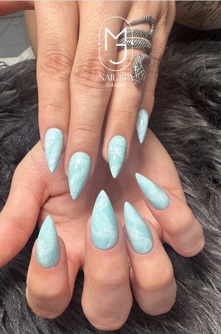 Nails featuring turquoise marble design with icy shimmer