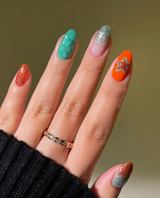 colorful nails featuring red and green glitter ombré