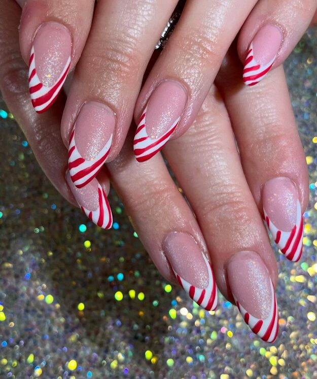 Glittery French tip nails with red and white striped design