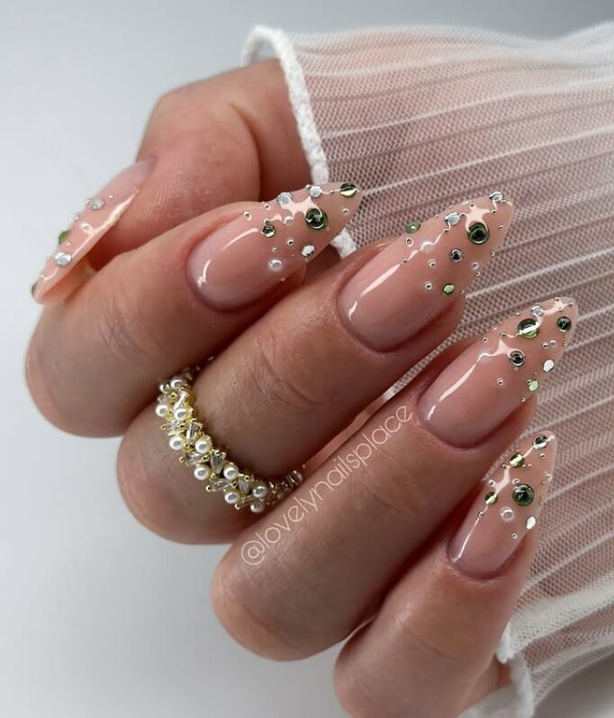 nails decorated with scattered gold and silver metallic confetti on the tips