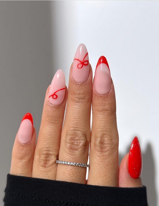 nails with diagonal red and white ribbon-like stripes.