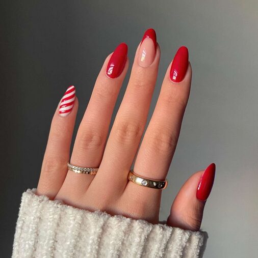 Jelly nails with clear red base and white swirl design on one finger