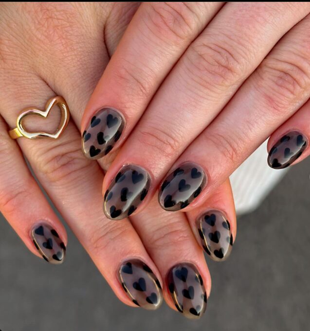 soft beige and black marble nails with heart designs