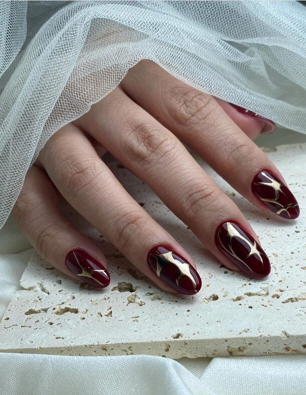 Gradient blend of maroon and copper nail colors