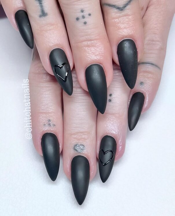 Matte black nails with smooth texture and minimal gothic style.