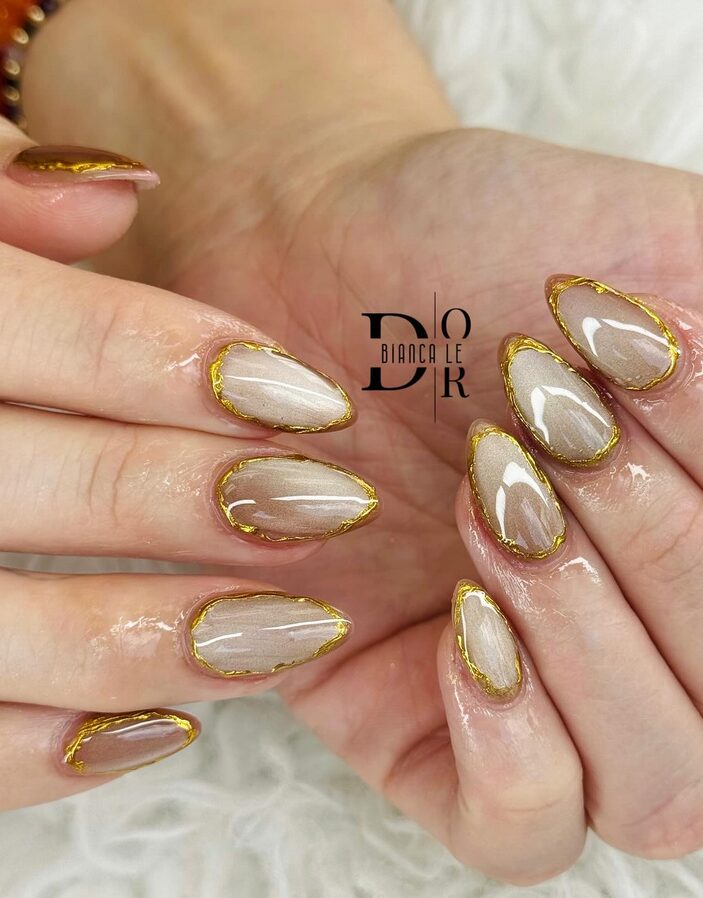 nude nails with gold foil accents