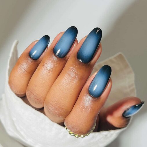 Midnight dark nails in deep black and navy tones with a glossy finish