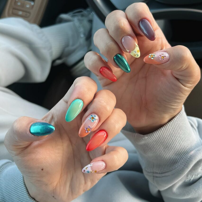 multi-color nails featuring chrome blue, green, red, peach, and nude shades