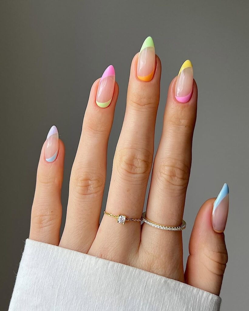 nails with glossy nude base and multicolor pastel French tip design