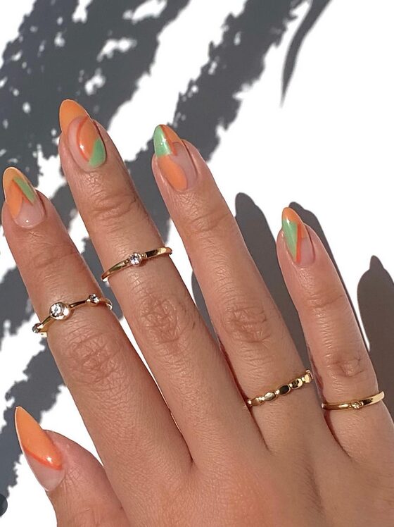 negative space nails with green and orange